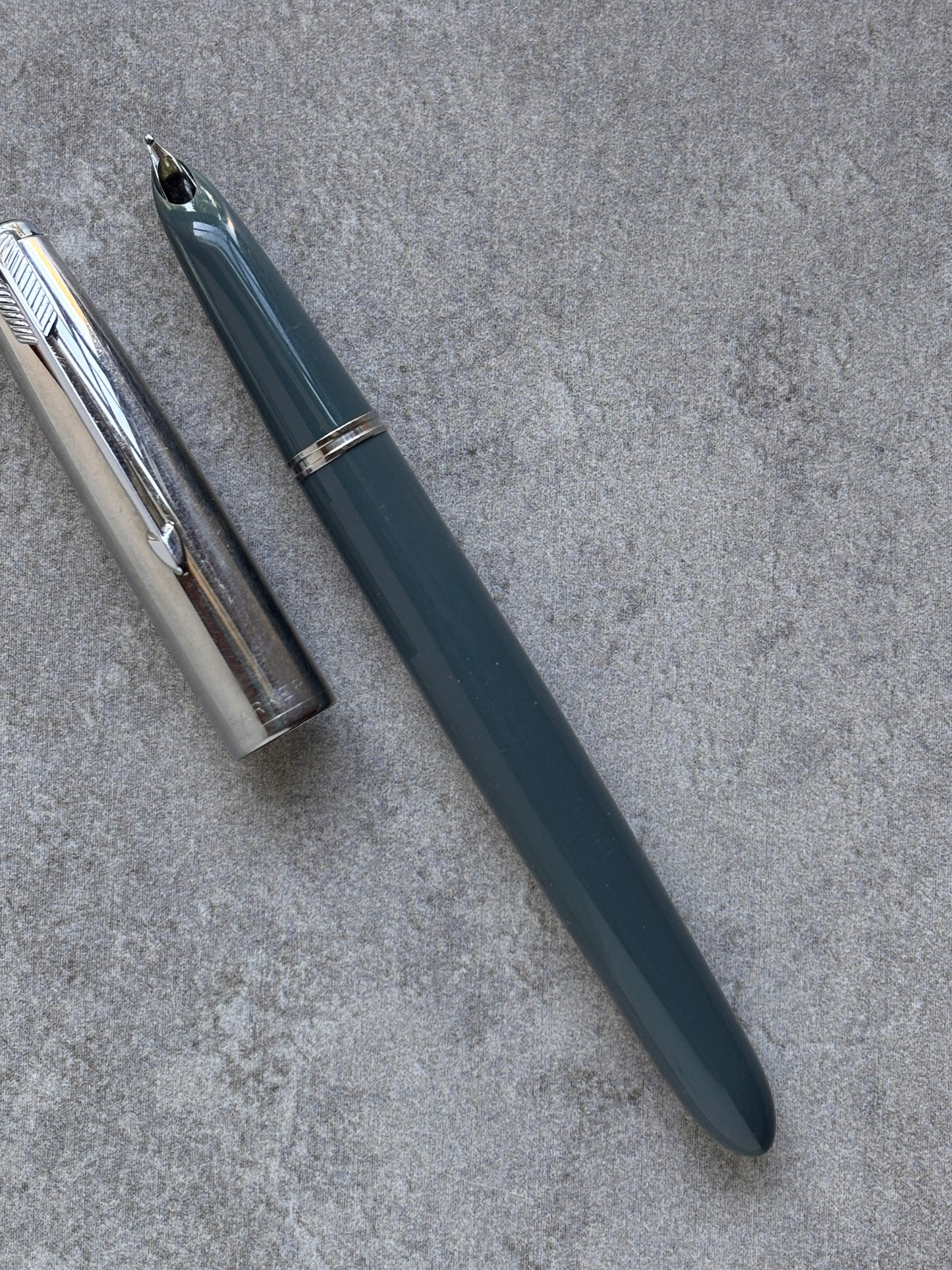 Fountain pen on a textured gray surface