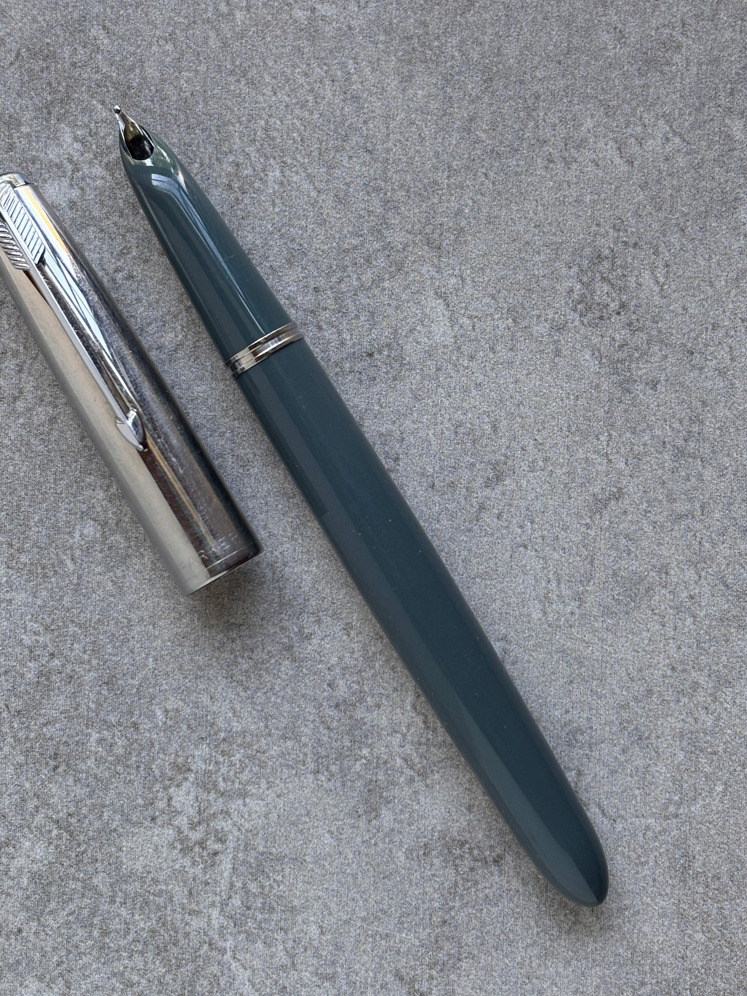 Fountain pen on a textured gray surface