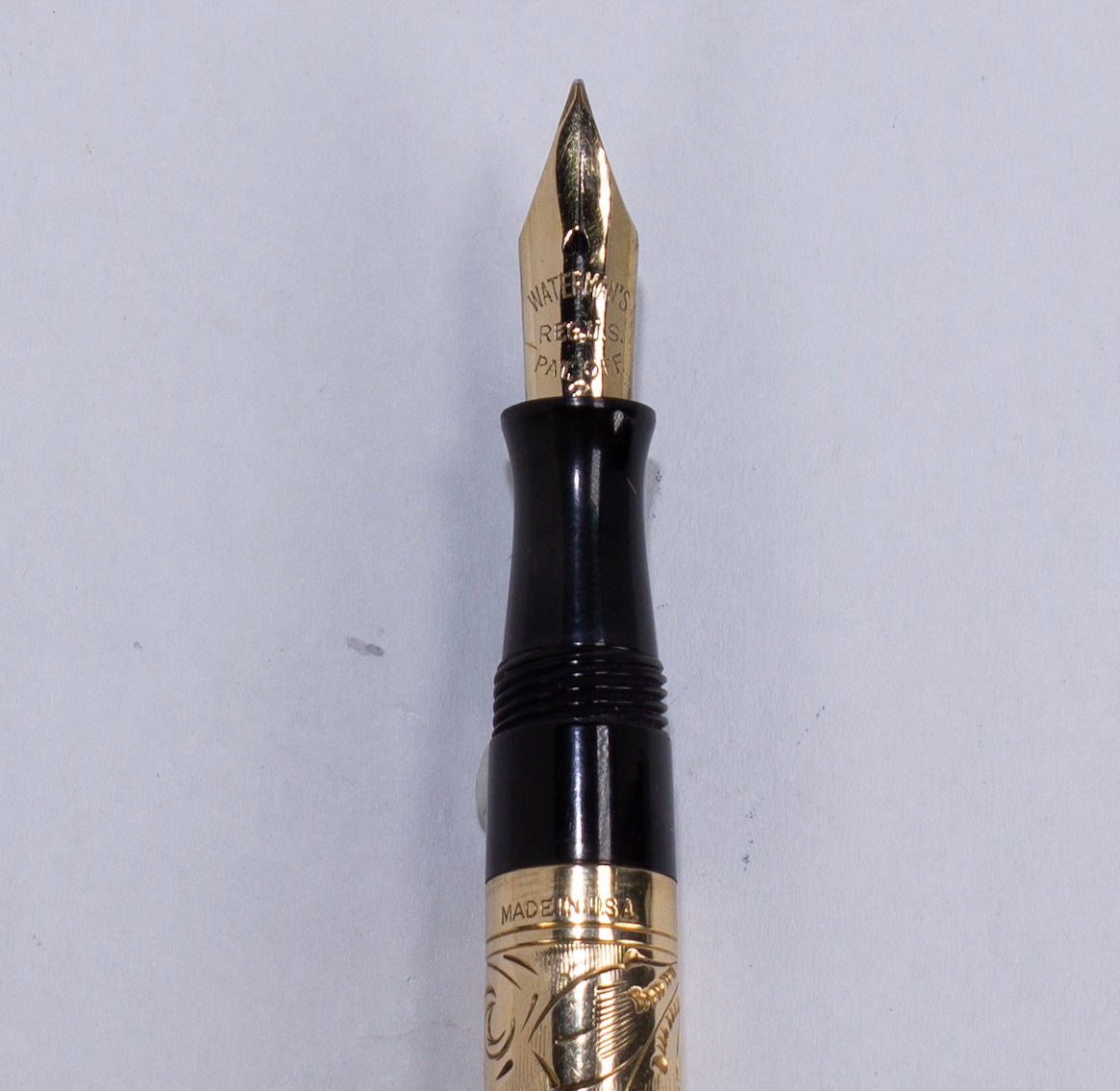 ${titleName/Type: Waterman 0552 1/2 V Manufacture Year: 1920s Length: 3 1/2 Filling System: Lever Filler Restored with a new sac. Color/Pattern: Gold filled cap and barrel, hand engraved flowers and vines Nib Type/Condition and remarks: 14K Gold Waterman