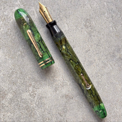 Green marbleized fountain pen on a gray surface
