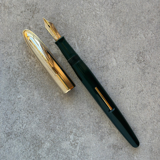 Fountain pen with gold accents on a gray surface