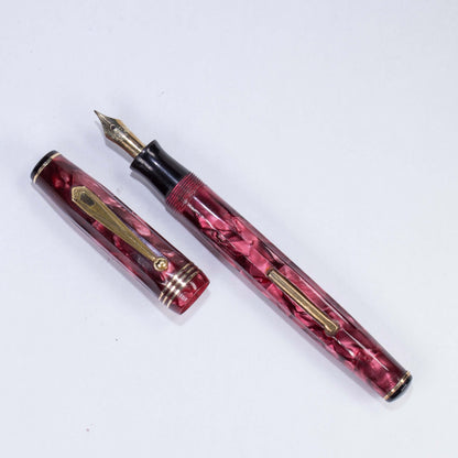 Parker Parkette Deluxe Red Marbled and Fluted Fountain Pen. Fully restored with a Fine 14K gold Parkette Nib Name/Type: Parkette Deluxe by Parker Manufacture Year: 1936 Length: 5 Filling System: Lever filler with new sac Color/Pattern: Red marbled fluted