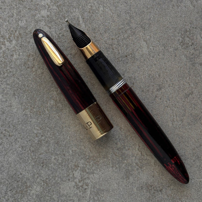 Fountain pen with gold accents on a gray surface