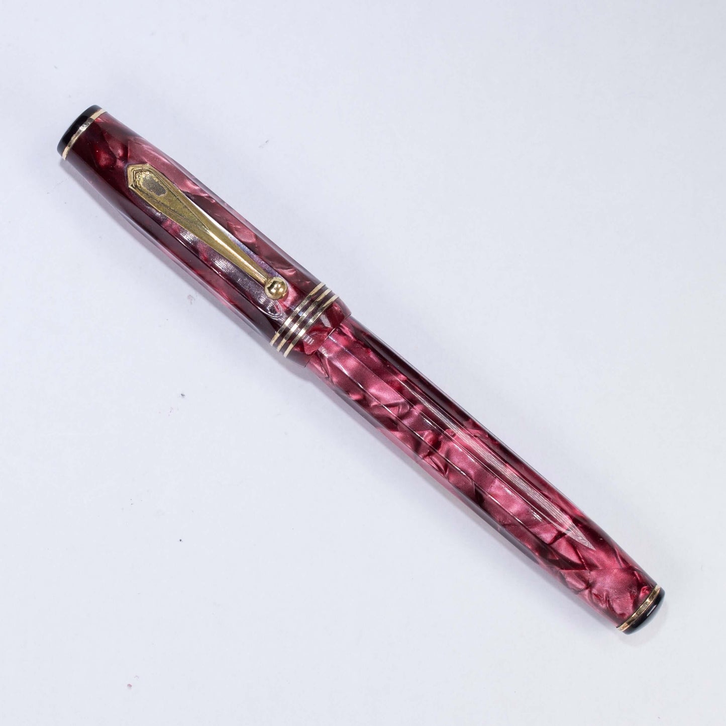 Parker Parkette Deluxe Red Marbled and Fluted Fountain Pen. Fully restored with a Fine 14K gold Parkette Nib Name/Type: Parkette Deluxe by Parker Manufacture Year: 1936 Length: 5 Filling System: Lever filler with new sac Color/Pattern: Red marbled fluted