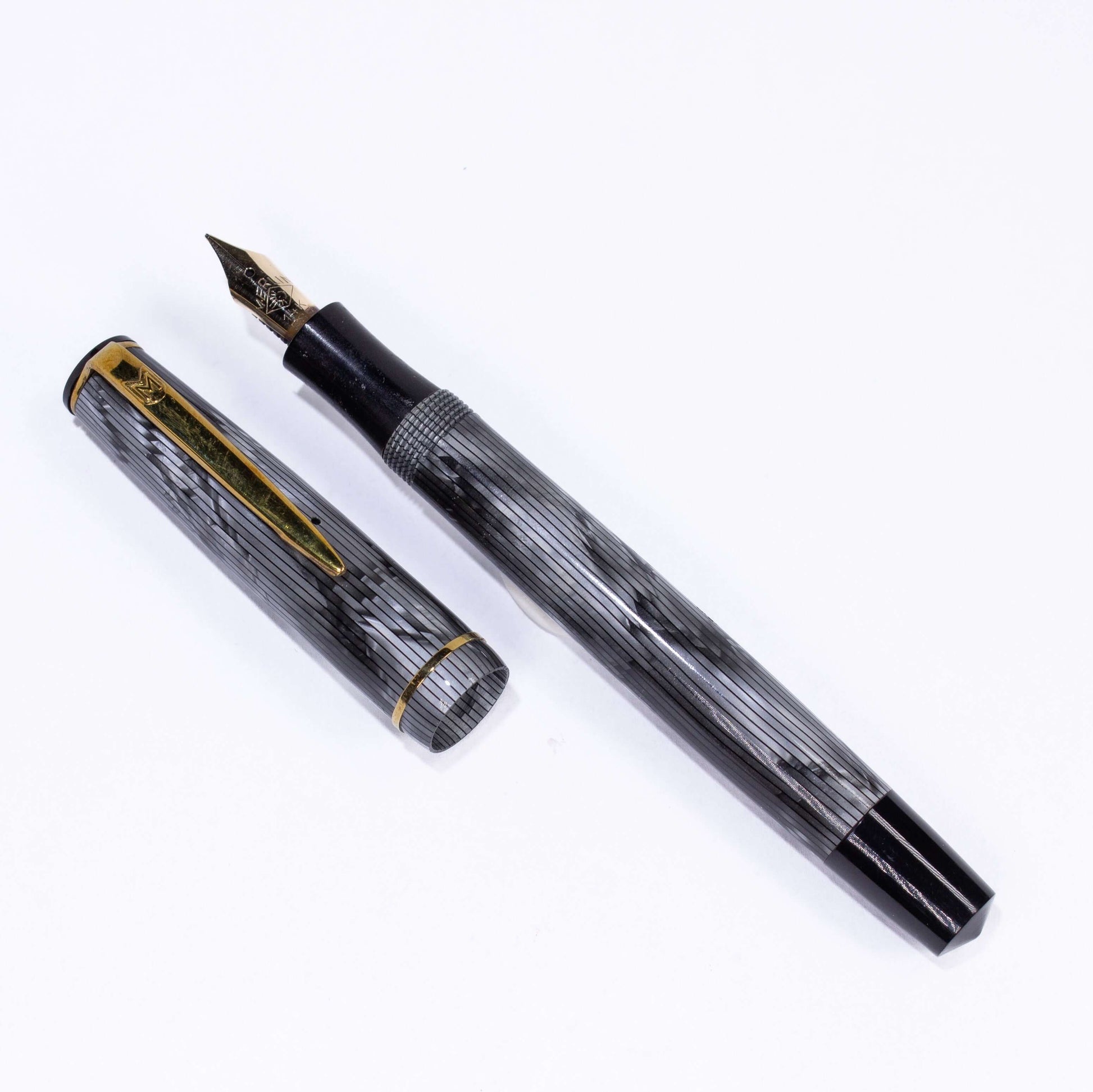 Merlin 33 Fountain Pen, Grey Pearl, Gold Trim 14K Merlin Nib, Flexible, Button Filler with New Sac Installed Type: Vintage Button Filler Fountain Pen Product Name: Merlin Manufacture Year: 1950s, made in Europe Length: 4 3/4 Filling System: Button Filler,
