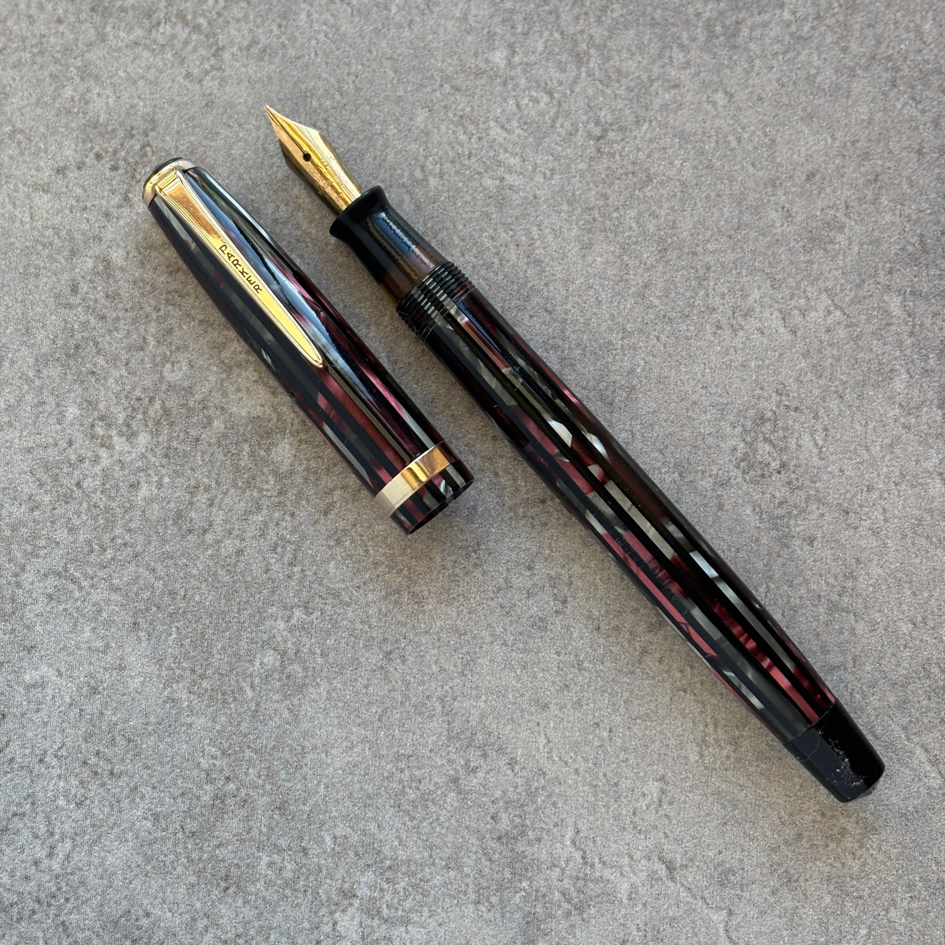 Fountain pen with gold accents on a gray surface
