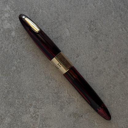 Fountain pen with gold accents on a gray surface