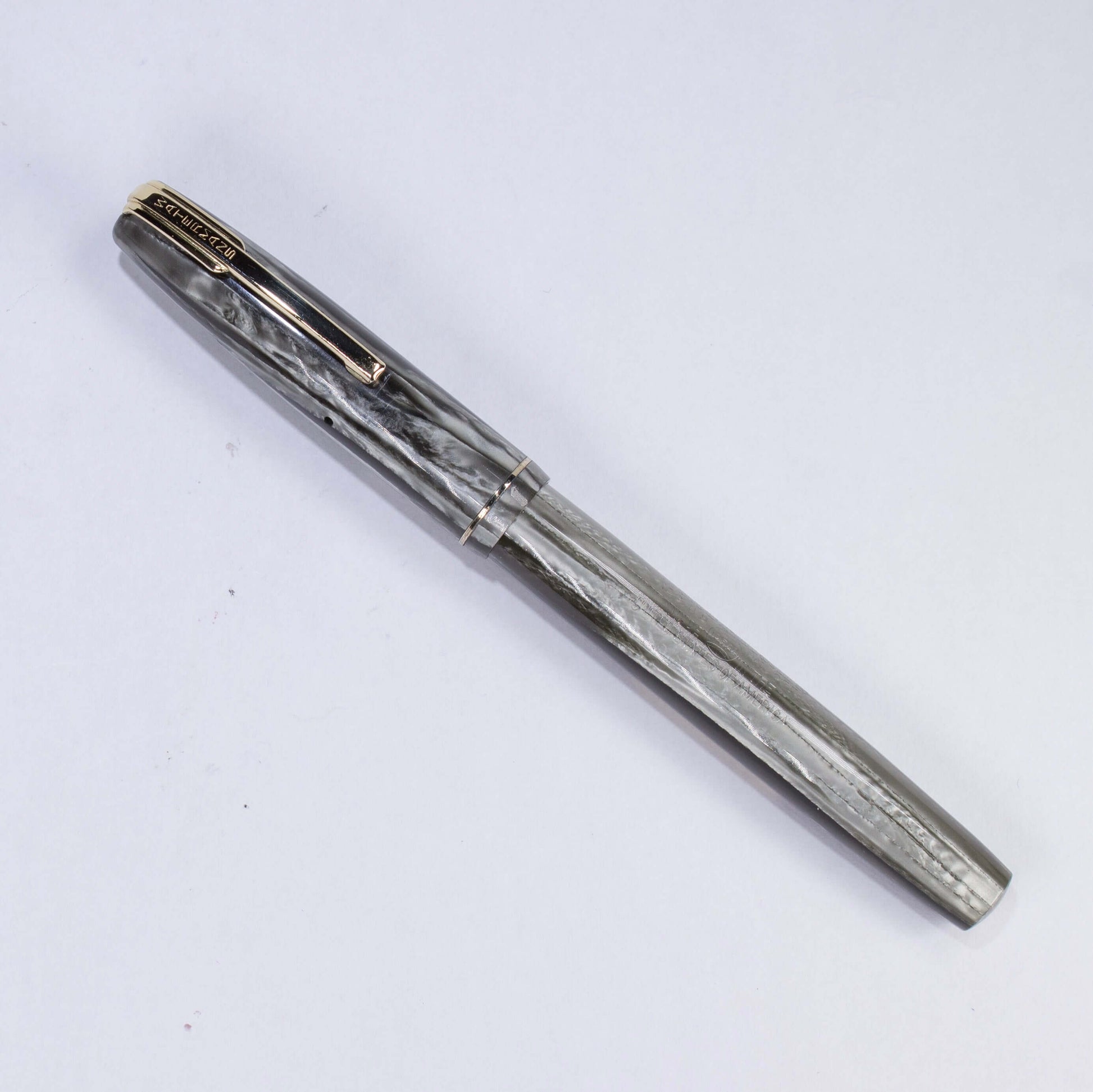 ${title﻿Name/Type: Waterman Stalwart Manufacture Year: Circa late 1940s Length: 5 Filling System: Lever Filler with new sac Color/Pattern: Striped Grey Marble, Gold plated clip and trim Nib Type/Condition and remarks: Medium 14K Gold Waterman nib, a littl