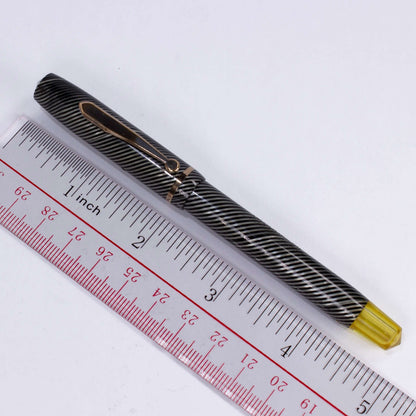${titleName/Type: Vacuum-Fil, Twist filler Manufacture Year: 1930s Length: 5 Filling System: Twist Fill, Fill by turning yellow knob, it wrings out the sac. Color/Pattern: Black and Grey Spiral Nib Type/Condition and remarks: 12K Gold Flexy nib, #3 size.
