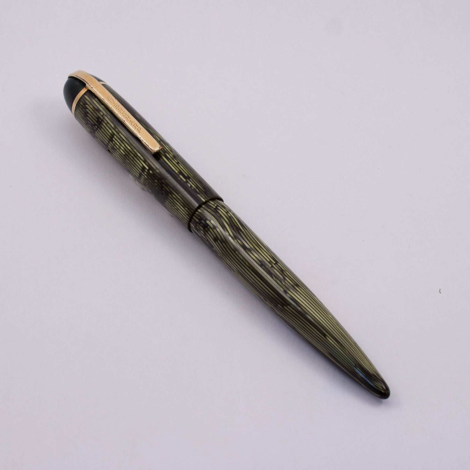 Eversharp Skyline Fountain Pen, Modern Strip Green Cap and Barrel, Gold Filled Trim, Fine 14k Nib Type: Restored Lever Filling Fountain Pen Product Name: Eversharp Skyline Manufacture Year: 1940's Length: ﻿5 1/4 Filling System: Lever Filler, restored with