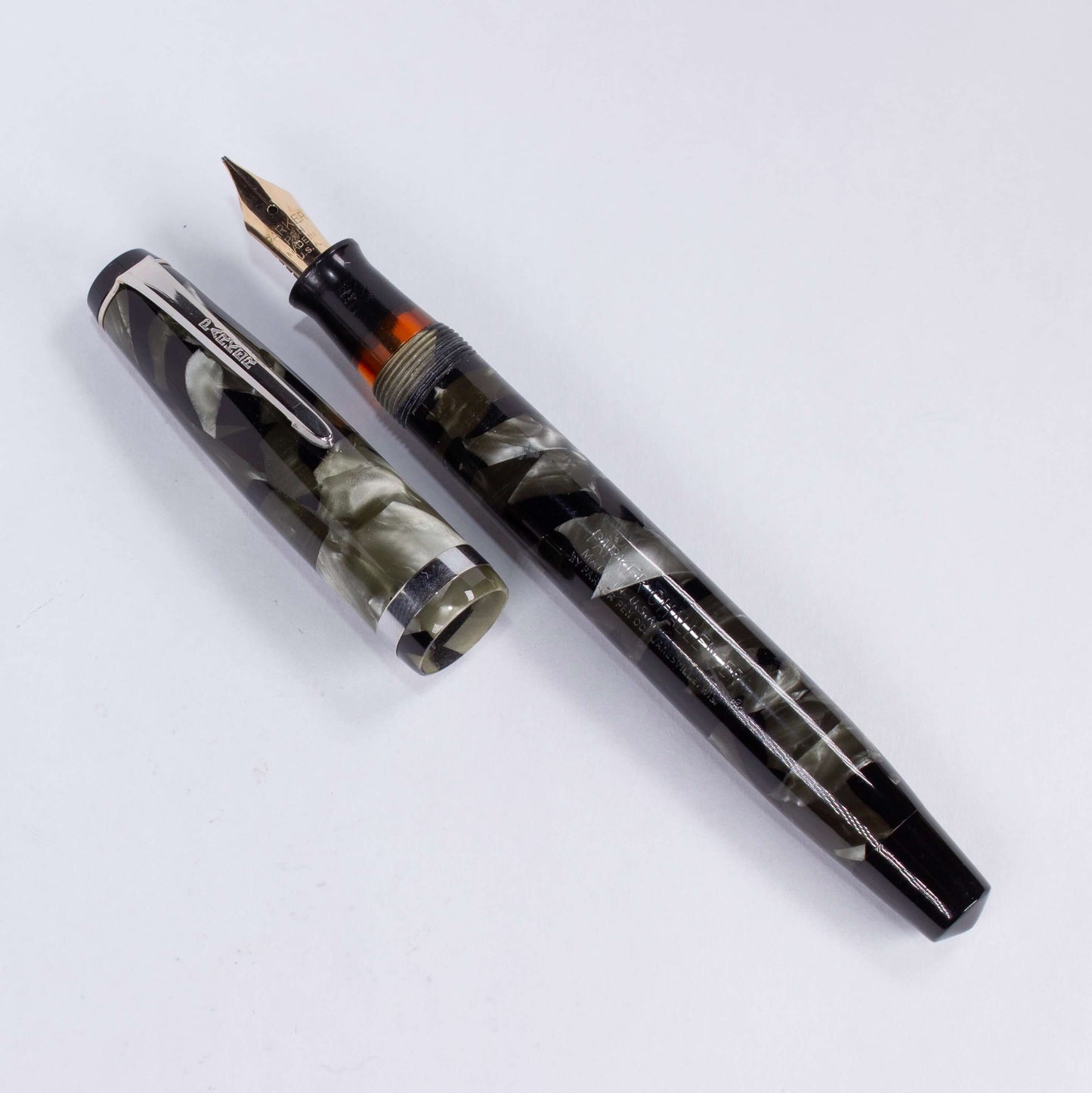 Parker Challenger Fountain Pen, Grey Marbled, Nickel Plated Clip and Cap Band, Button Filler, 14K Gold Nib Name/Type: Parker Challenger Restored Vintage Fountain Pen Manufacture Year: 1930s Length: 5 Filling System: Button Filler Color/Pattern: Grey Marbl