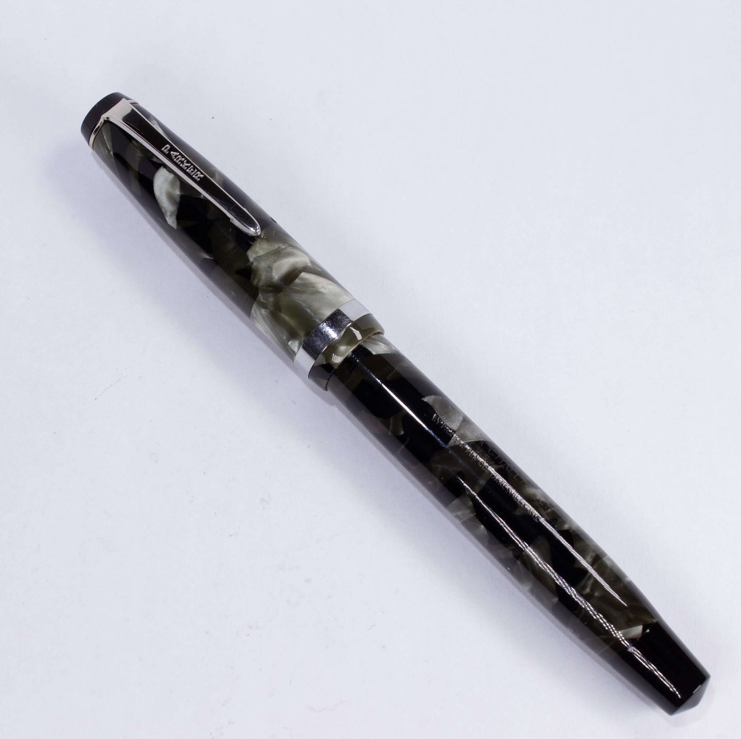 Parker Challenger Fountain Pen, Grey Marbled, Nickel Plated Clip and Cap Band, Button Filler, 14K Gold Nib Name/Type: Parker Challenger Restored Vintage Fountain Pen Manufacture Year: 1930s Length: 5 Filling System: Button Filler Color/Pattern: Grey Marbl