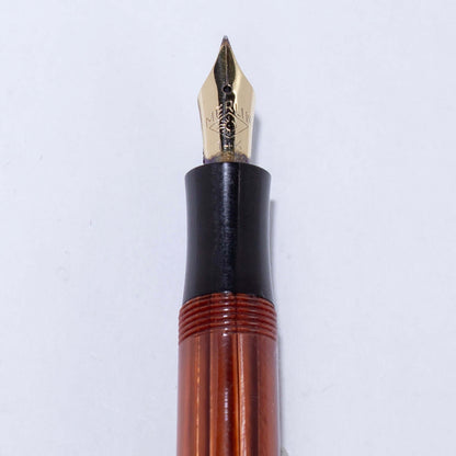 Merlin 33 Fountain Pen, Rootbeer Cap and Barrel, 14K Merlin Nib, Flexible, Button Filler with New Sac Installed Type: Vintage Button Filler Fountain Pen Product Name: Merlin Manufacture Year: 1950s, made in Europe Length: 4 3/4 Filling System: Button Fill