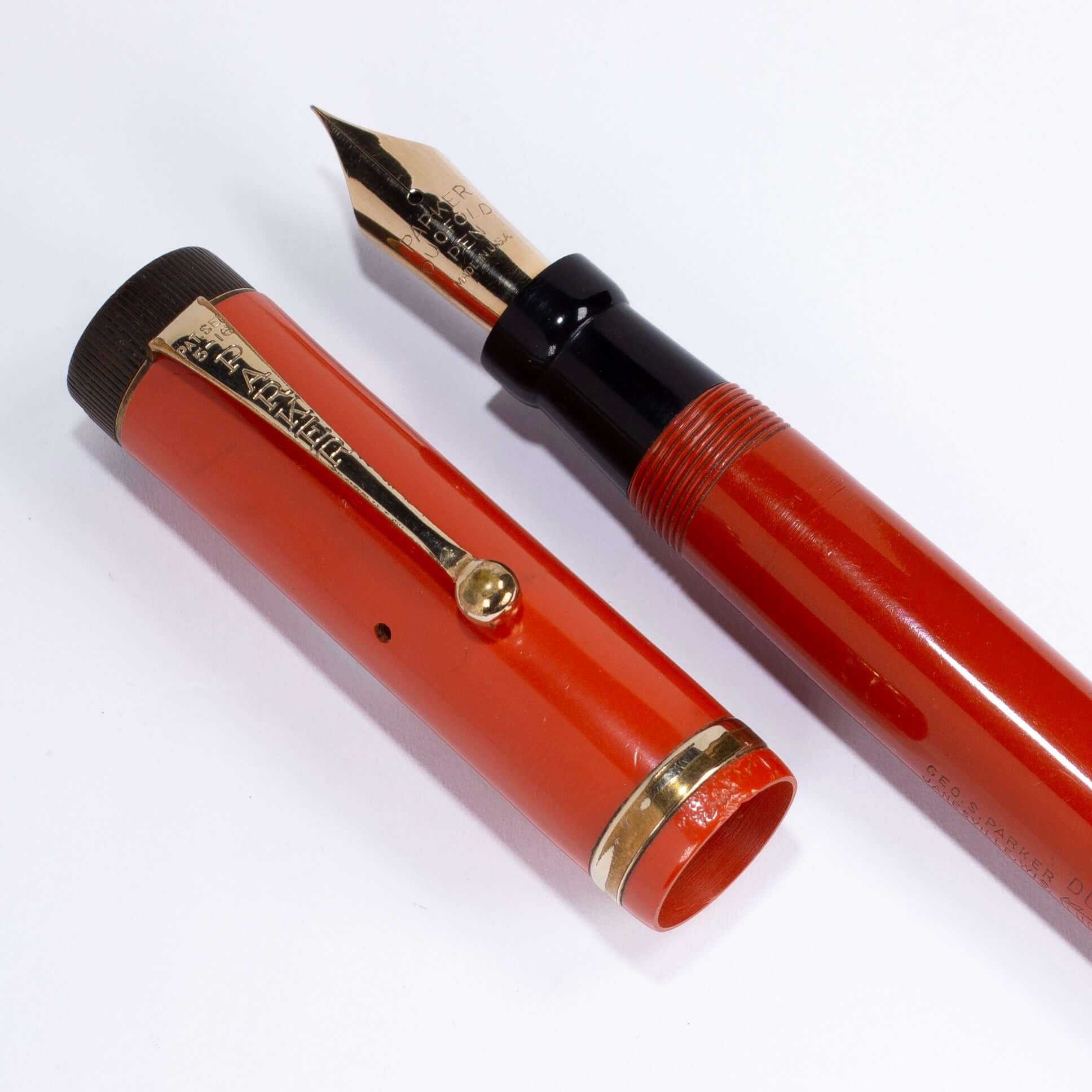 Parker Duofold Senior, Red Hard Rubber, Raised Cap Band, Button Fill, Large 14K Gold Duofold nib. Comes in original box with instruction sheet. Name/Type: Parker Senior Duofold Manufacture Year: 1920s Length: 5 1/2 Filling System: Button filler; Restored