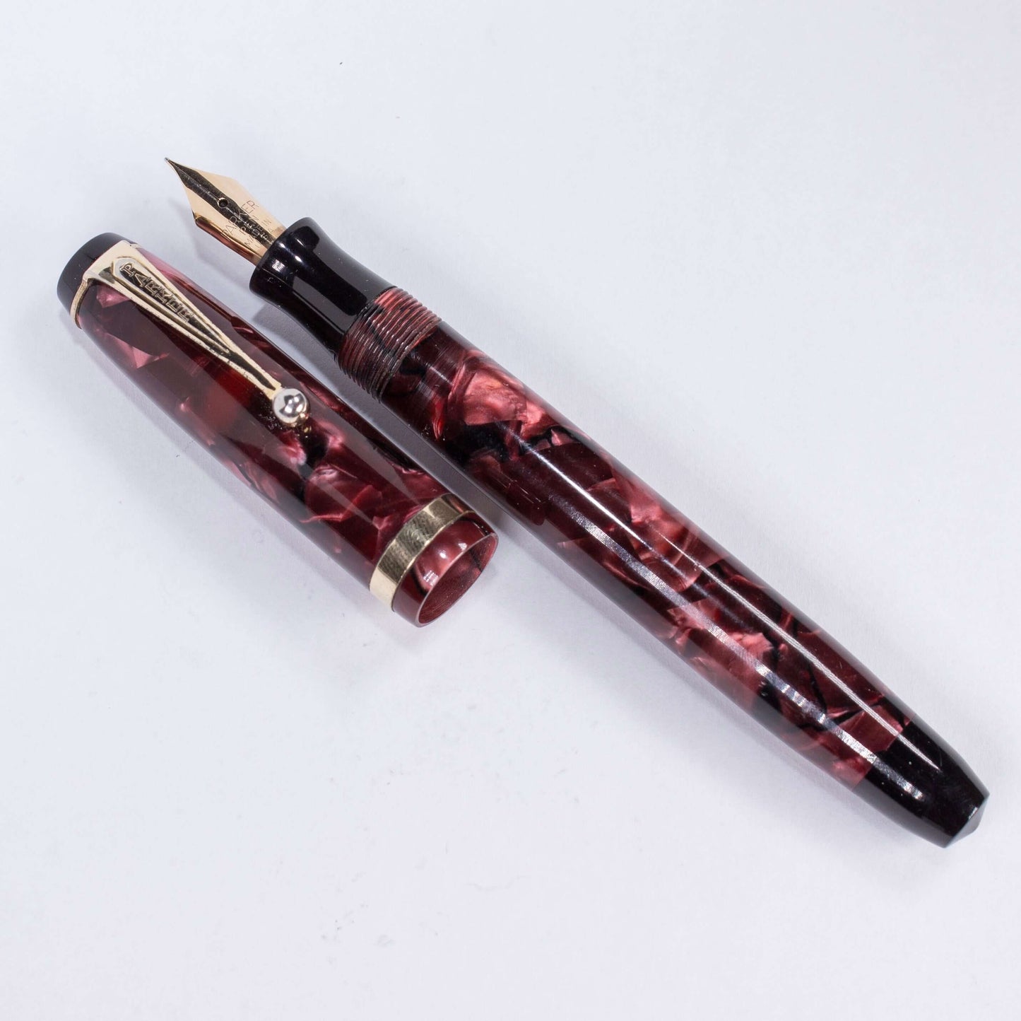 Parker Challenger Fountain Pen, Red Marbled, Button Filler, 14K Gold Nib Name/Type: Parker Challenger Restored Vintage Fountain Pen Manufacture Year: 1930s Length: 5 Filling System: Button Filler Color/Pattern: Red Marbled, Gold filled trim and cap band N