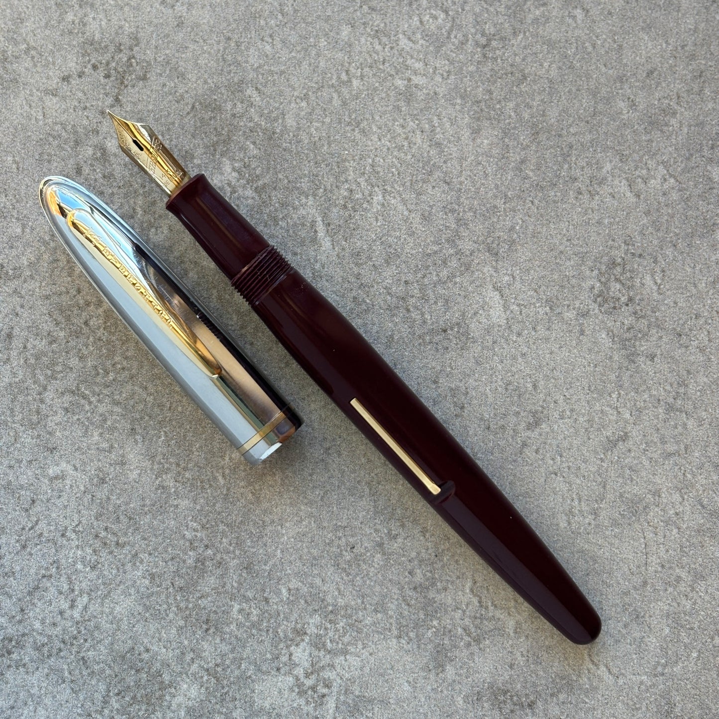 Fountain pen with gold accents on a gray surface