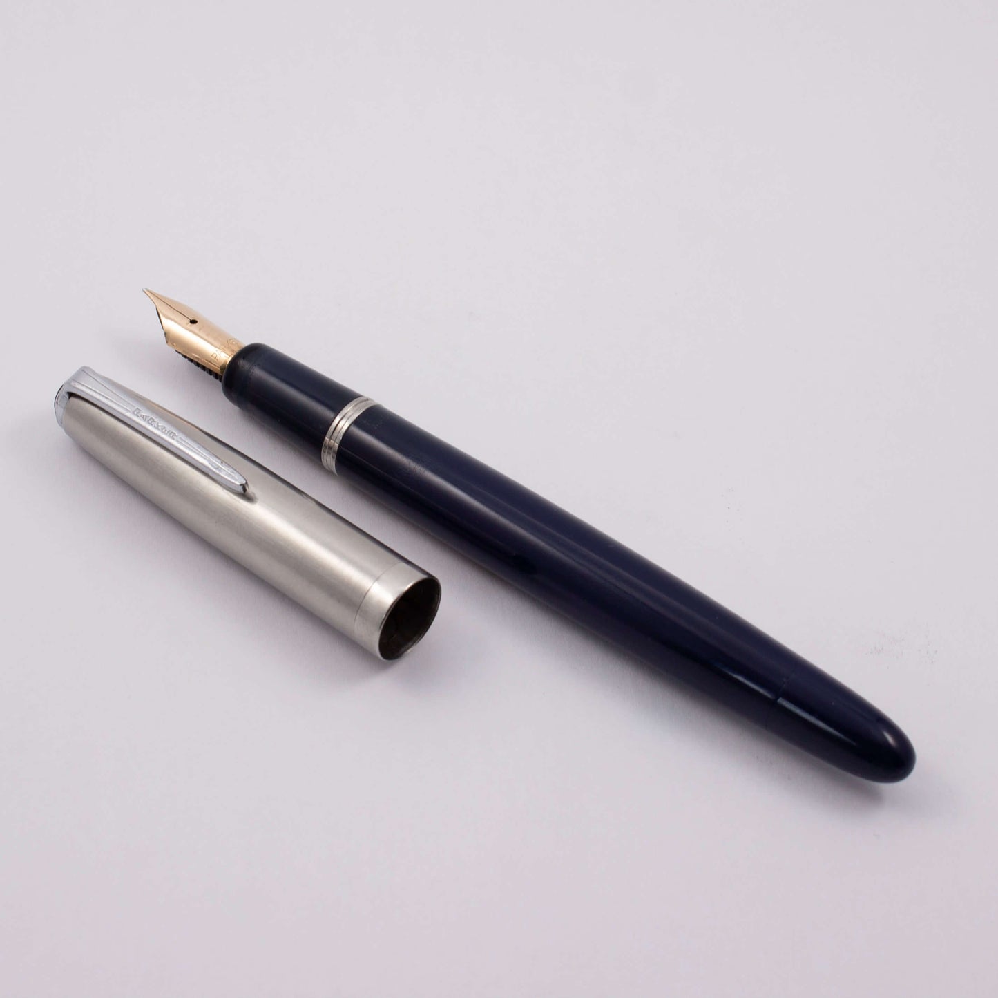 Parker VS Fountain Pen, 1947, Royal Blue with a Lustraloy Cap, Button Filler with a 14k Gold Nib Type: Restored Fountain Pen Product Name: Parker VS Manufacture Year: 1947 Length: 5 1/2 Filling System: Button filler with aluminum button Color/Pattern: Roy