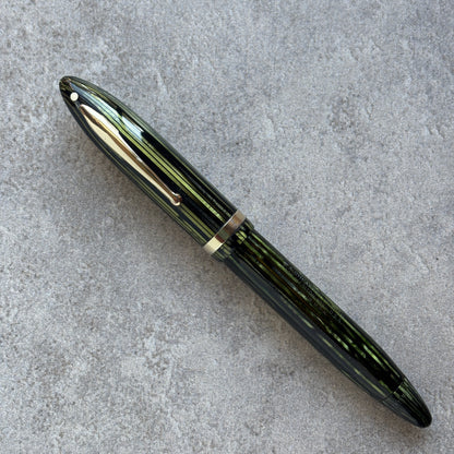 Marine Green fountain pen on a gray concrete surface