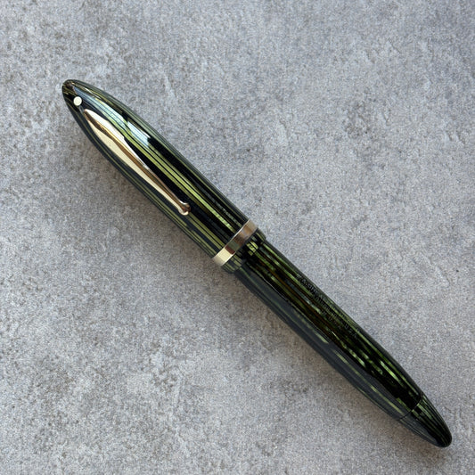 Marine Green fountain pen on a gray concrete surface