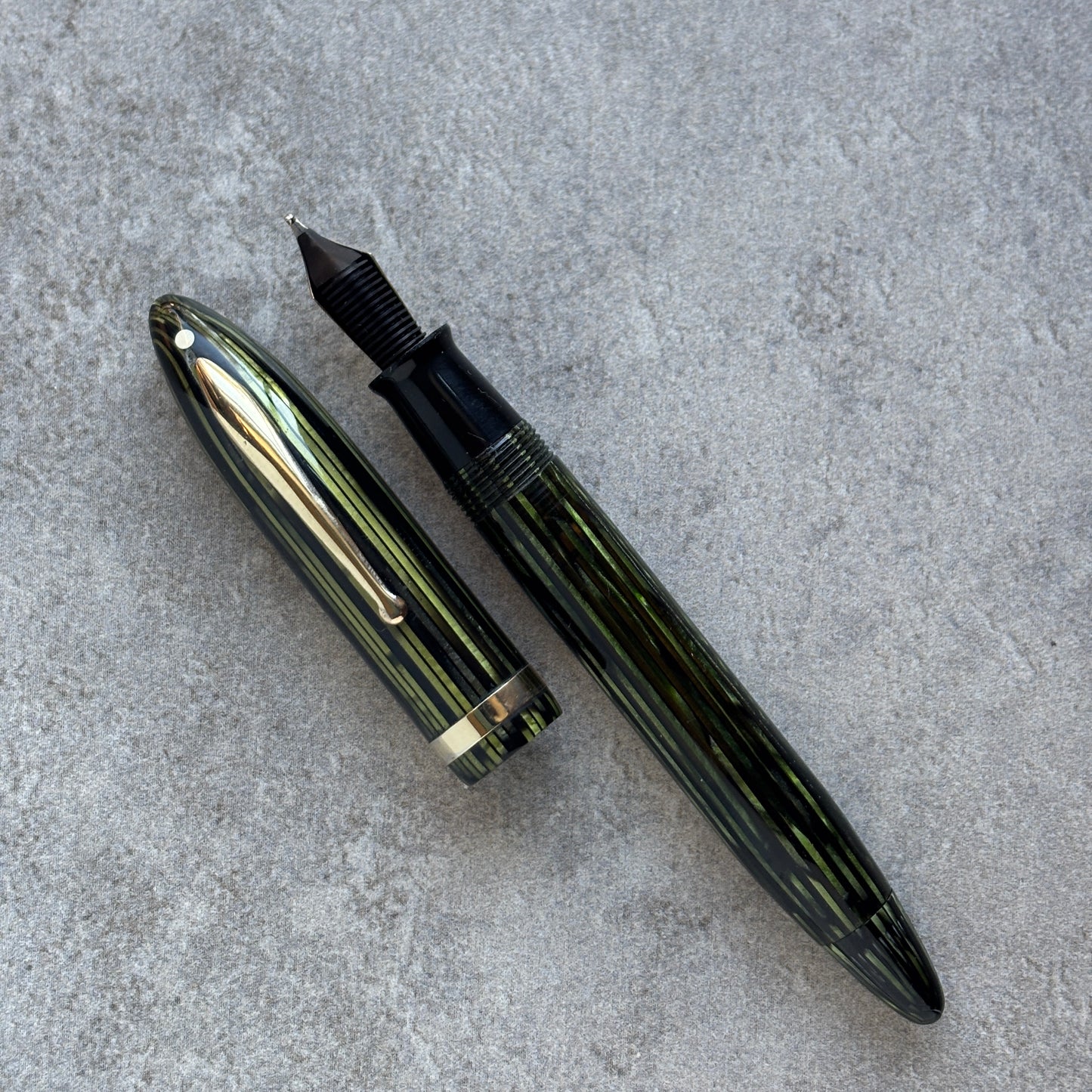 Fountain pen with gold accents on a gray surface