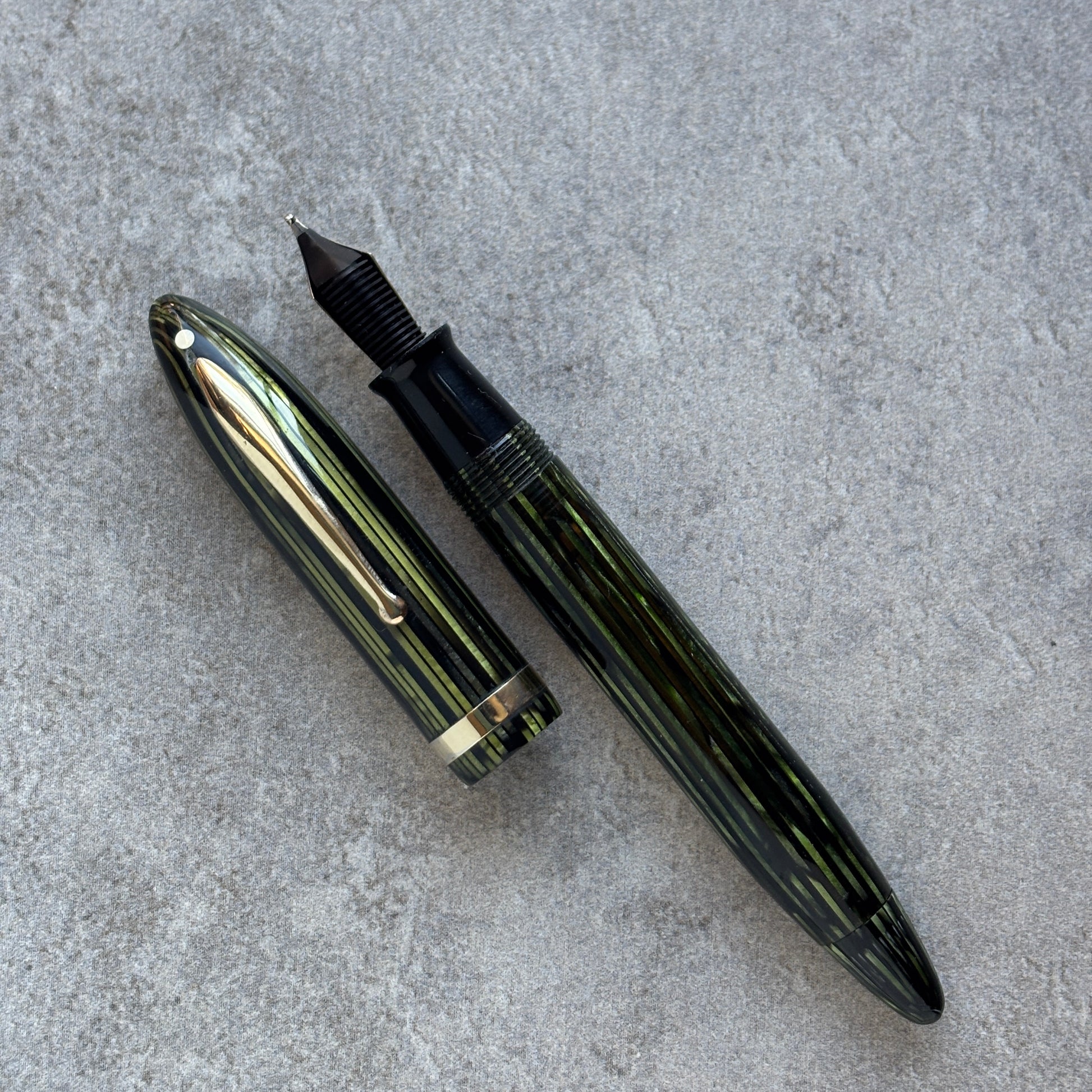 Fountain pen with gold accents on a gray surface