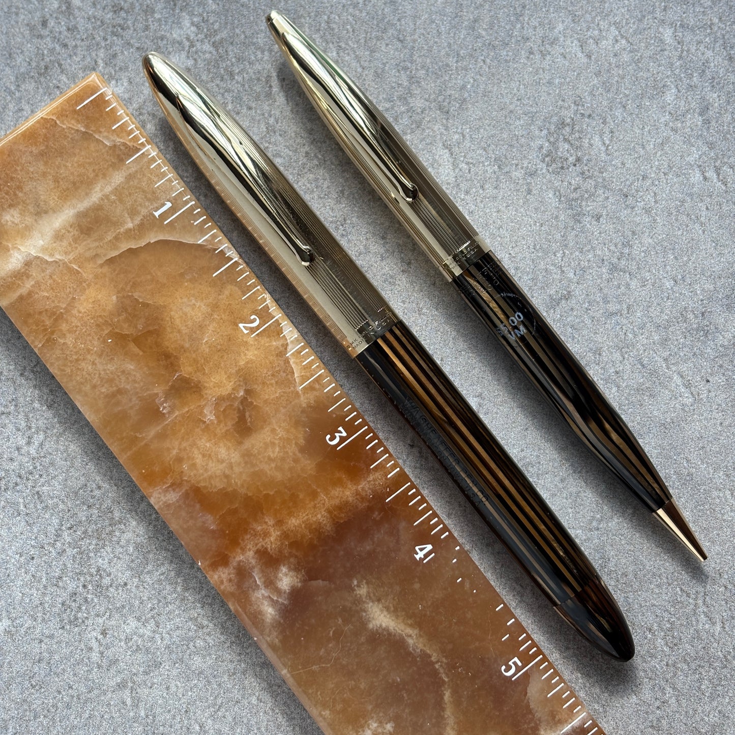 Pen and pencil  and a ruler on a textured surface