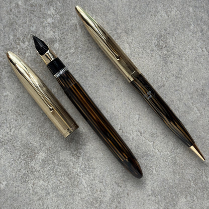 Fountain pen and its components on a gray surface