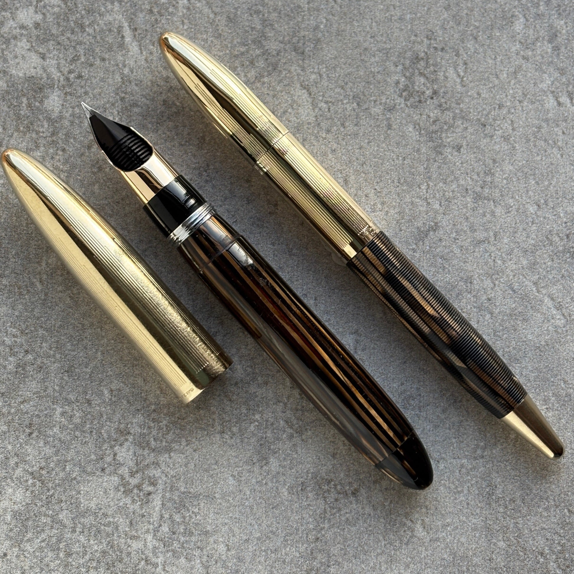 Fountain pen with gold accents on a gray surface