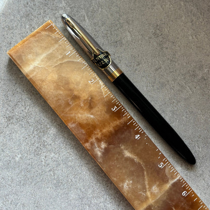 Pen and ruler on a textured surface