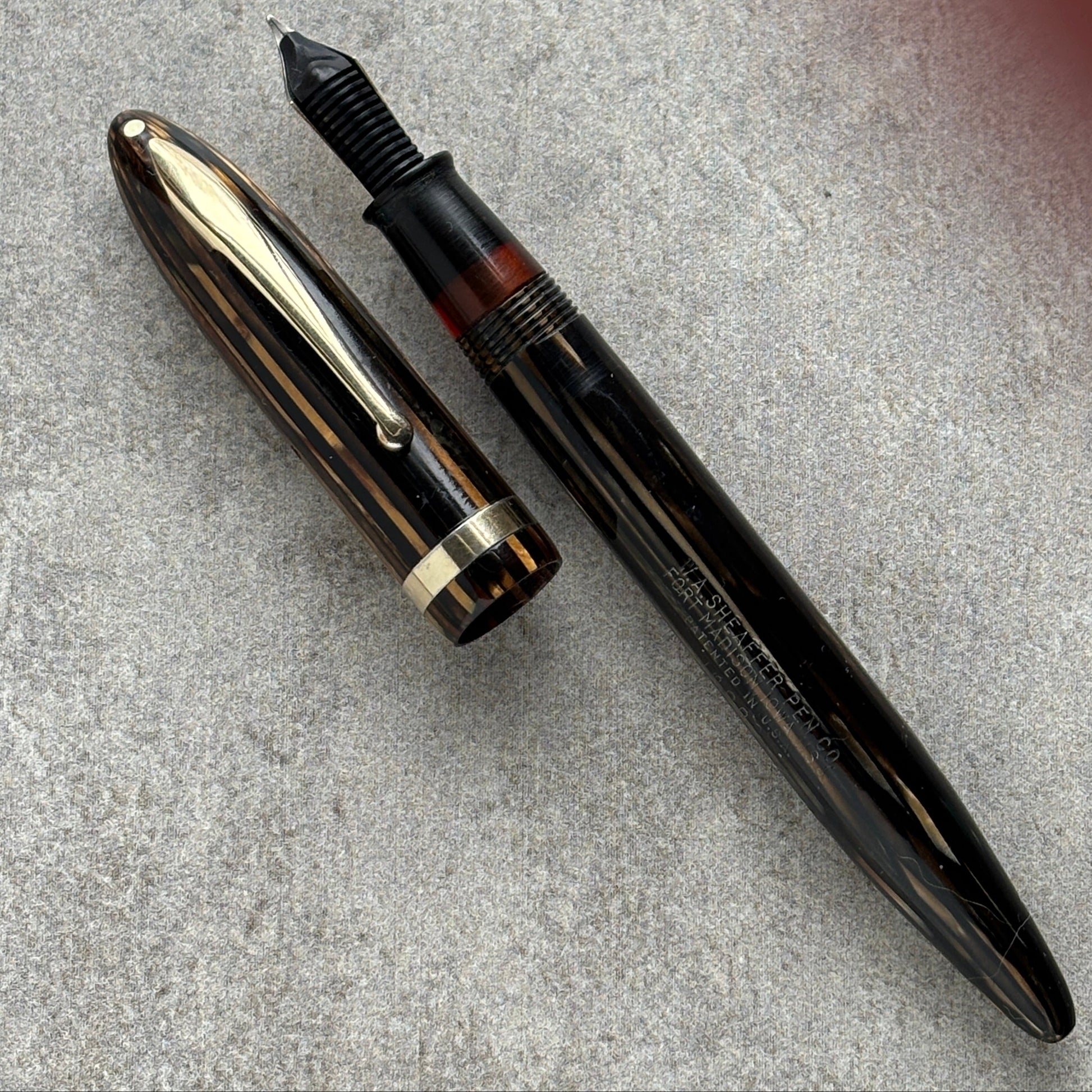 Fountain pen on a textured gray surface