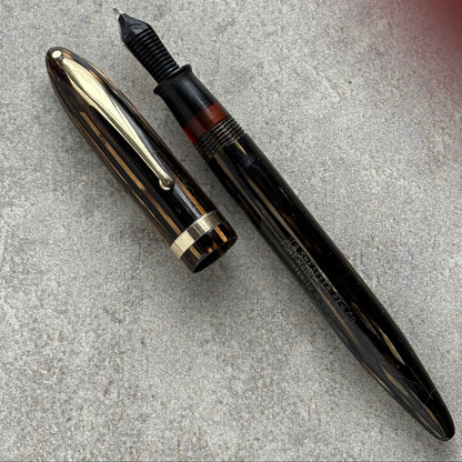 Fountain pen on a textured gray surface