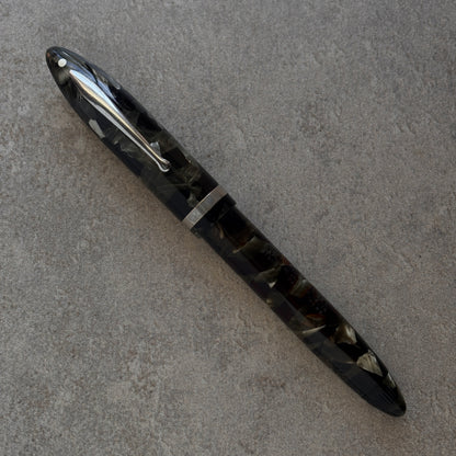 Black and silver pen on a gray surface