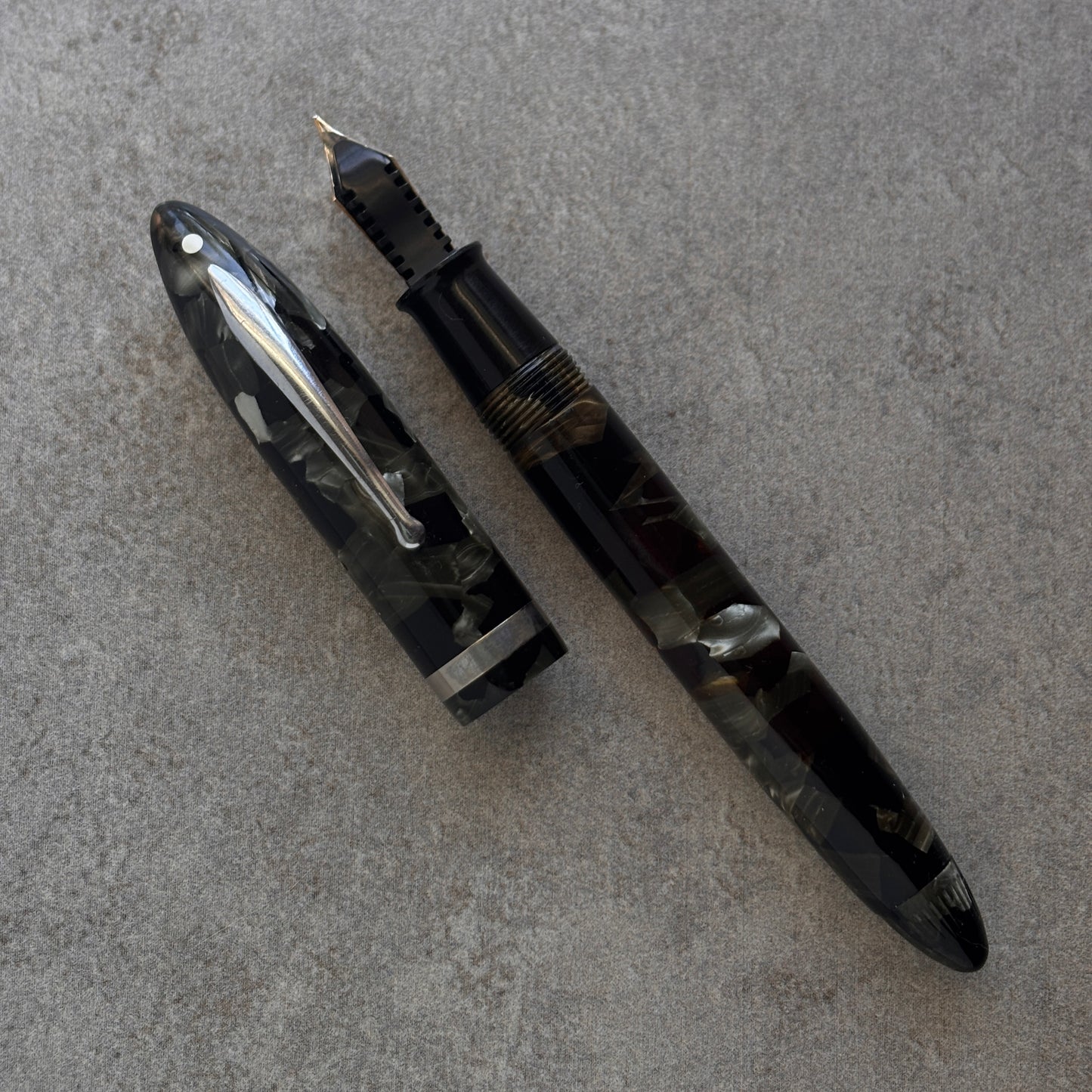 Fountain pen on a gray textured surface