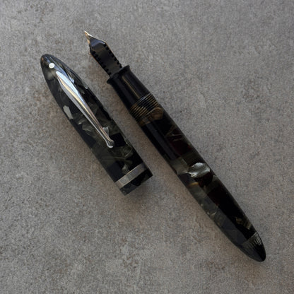 Fountain pen on a gray textured surface